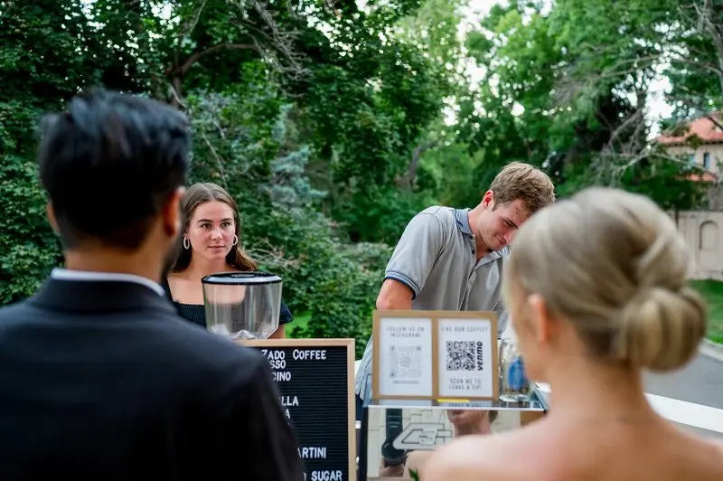 A couple ordering from a Zado barista at their wedding